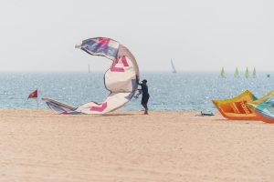 Man holding a kite on a beach