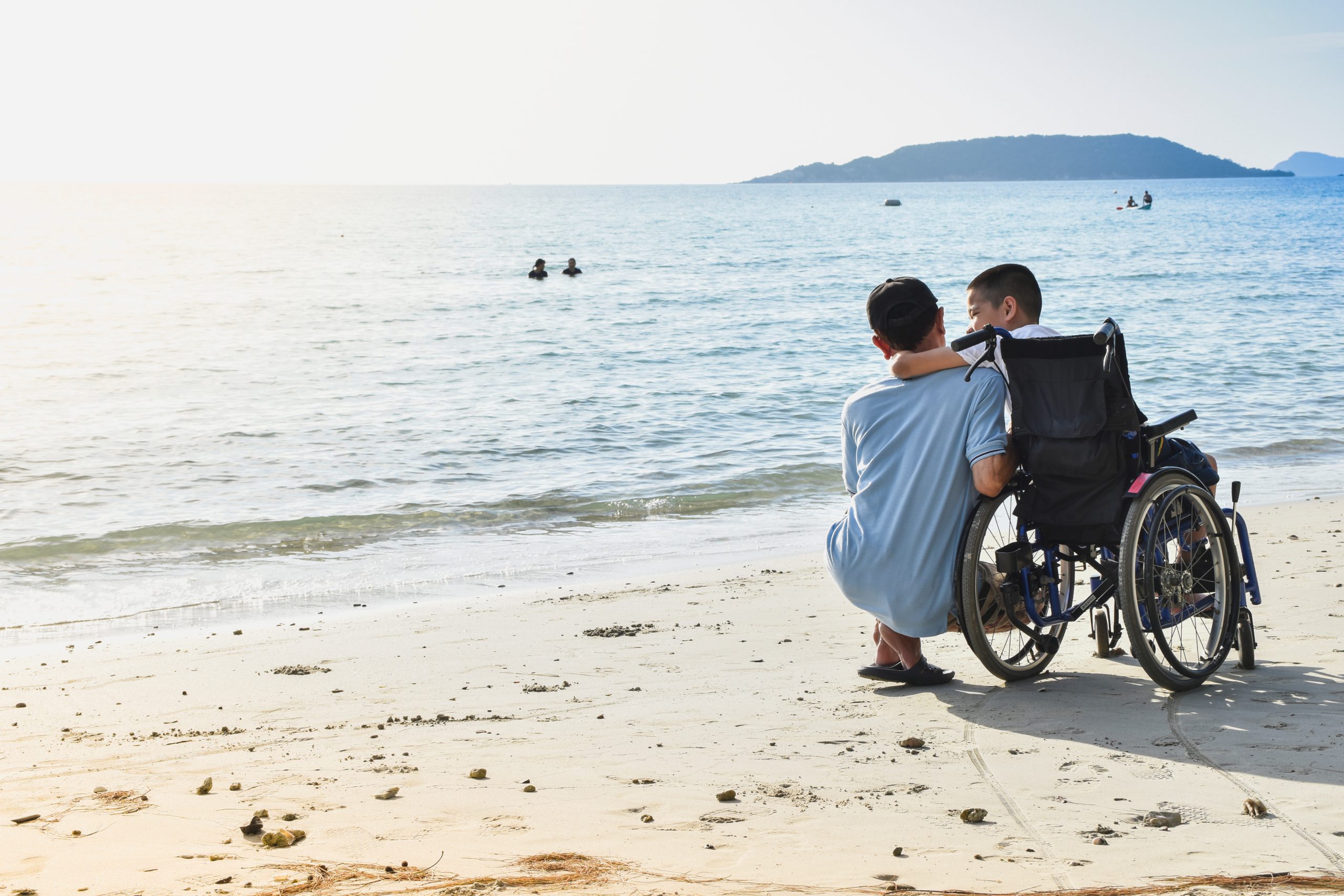 Boy in wheelchair on beach